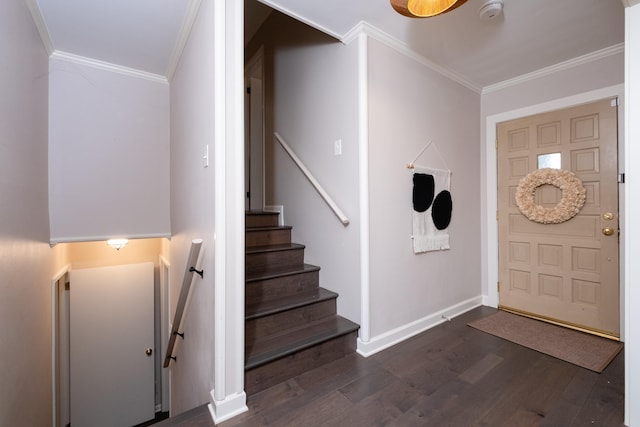 foyer entrance with crown molding and dark hardwood / wood-style floors