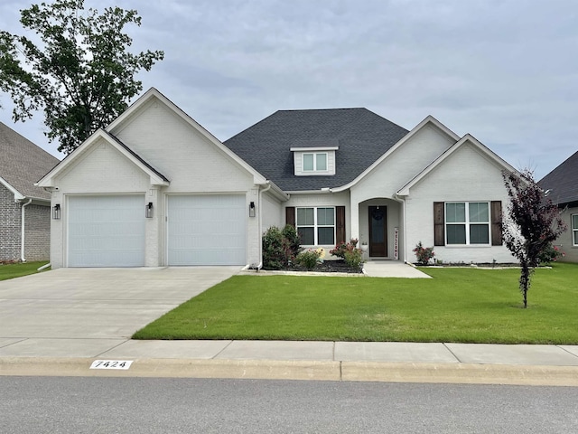 view of front of property with a garage, a shingled roof, brick siding, driveway, and a front yard