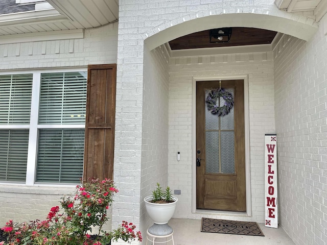 entrance to property with brick siding