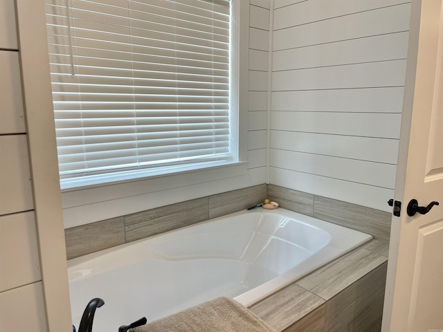 bathroom featuring tiled bath