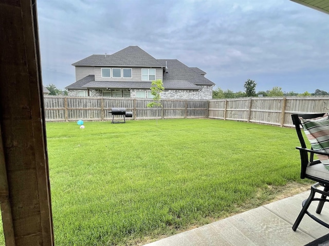 view of yard with a fenced backyard and a patio