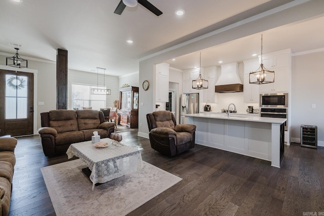 living room featuring beverage cooler, baseboards, dark wood-style flooring, and crown molding