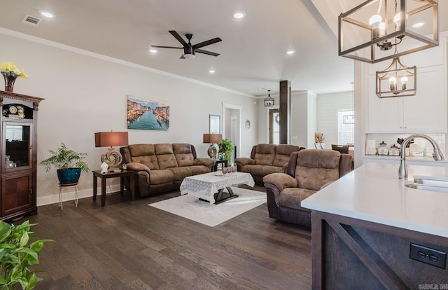 living room featuring crown molding, dark wood finished floors, recessed lighting, visible vents, and ceiling fan