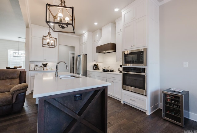 kitchen featuring a sink, light countertops, black appliances, decorative light fixtures, and custom range hood