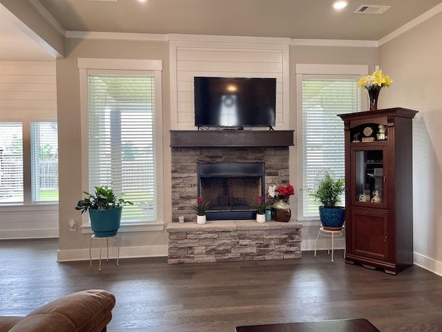 living room featuring crown molding, dark wood-type flooring, and a wealth of natural light