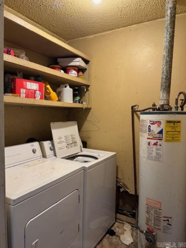 washroom featuring water heater and washing machine and clothes dryer