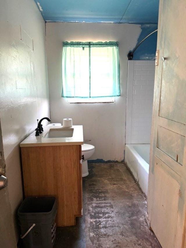 bathroom with vanity, concrete flooring, and toilet