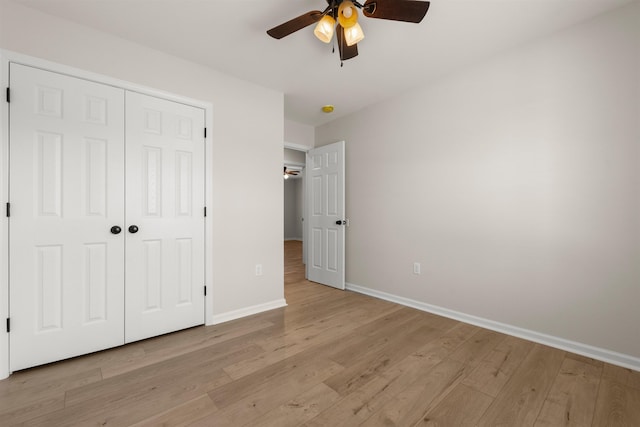 unfurnished bedroom featuring a closet, ceiling fan, and light hardwood / wood-style flooring