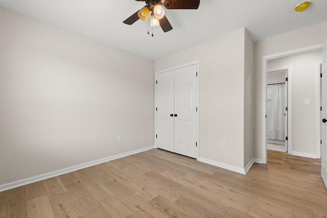 unfurnished bedroom featuring ceiling fan, light hardwood / wood-style floors, and a closet