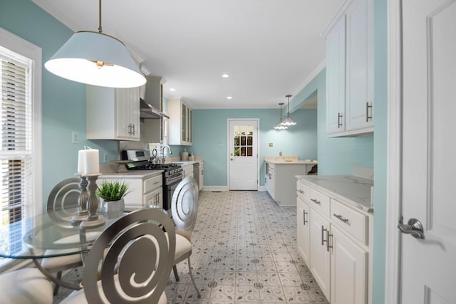 kitchen with white cabinetry, extractor fan, decorative light fixtures, and gas stove