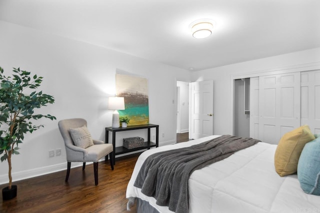 bedroom with dark hardwood / wood-style flooring and a closet