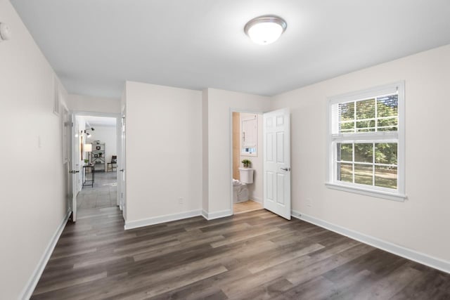 unfurnished bedroom with dark hardwood / wood-style flooring