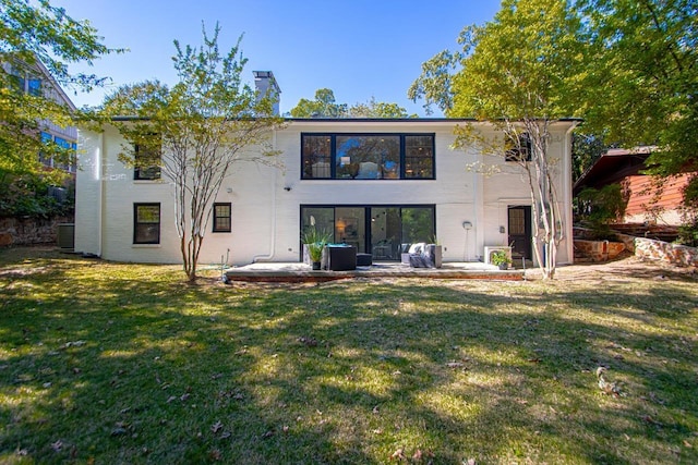 back of property featuring a patio area, central AC unit, and a lawn