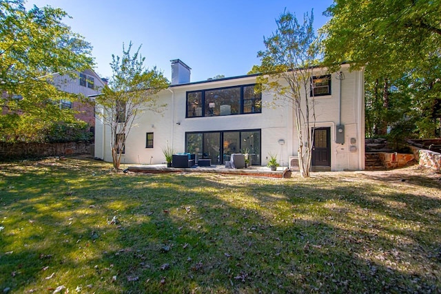 back of house featuring a yard and a patio area