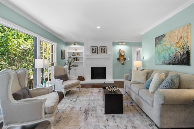 living room featuring a fireplace, built in features, light hardwood / wood-style flooring, and ornamental molding