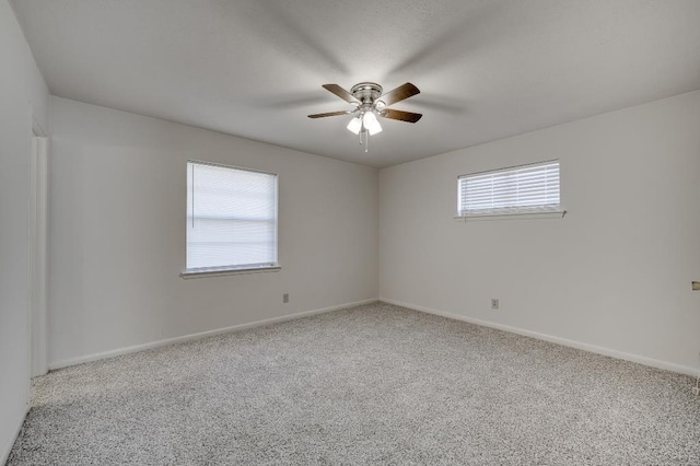 empty room featuring ceiling fan and carpet flooring