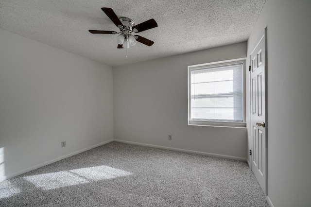 carpeted spare room with ceiling fan and a textured ceiling