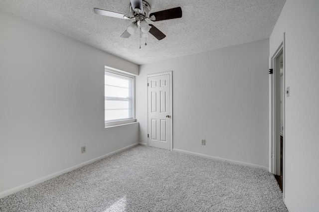 spare room with ceiling fan, carpet floors, and a textured ceiling