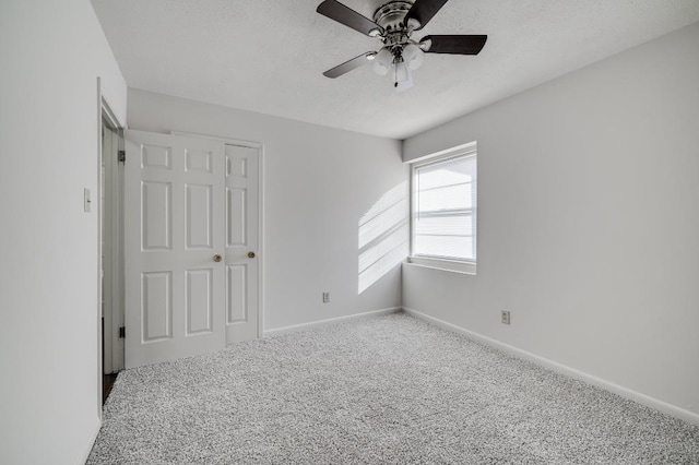 unfurnished bedroom with ceiling fan and carpet flooring