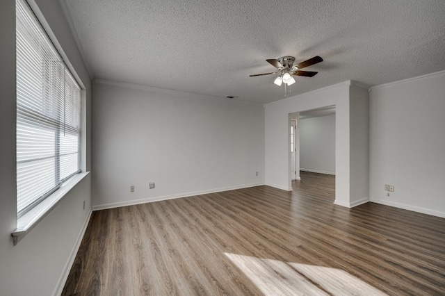 empty room featuring hardwood / wood-style flooring, ceiling fan, ornamental molding, and a textured ceiling