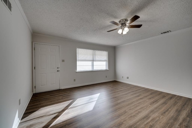 spare room with crown molding, ceiling fan, dark hardwood / wood-style flooring, and a textured ceiling