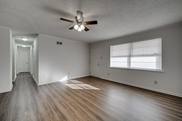 spare room with ceiling fan, ornamental molding, hardwood / wood-style floors, and a textured ceiling