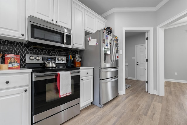 kitchen with white cabinetry, backsplash, stainless steel appliances, ornamental molding, and light wood-type flooring