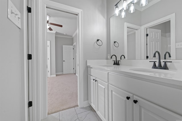 bathroom featuring ceiling fan, ornamental molding, and vanity