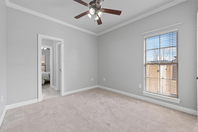 empty room featuring ceiling fan, ornamental molding, and light carpet