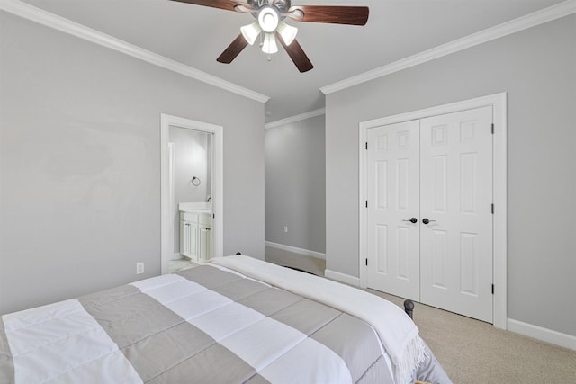 bedroom featuring ceiling fan, carpet, connected bathroom, ornamental molding, and a closet