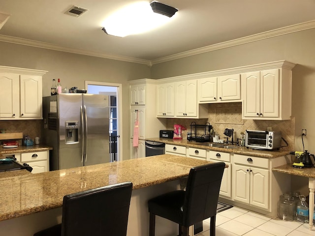 kitchen featuring stainless steel refrigerator with ice dispenser, white cabinetry, black dishwasher, and stone counters