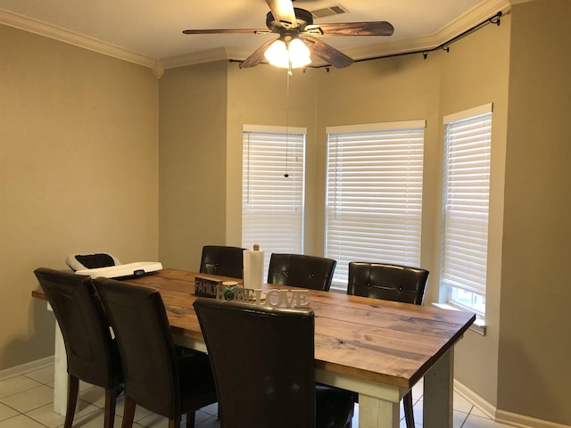 dining room with ceiling fan, ornamental molding, and light tile patterned floors