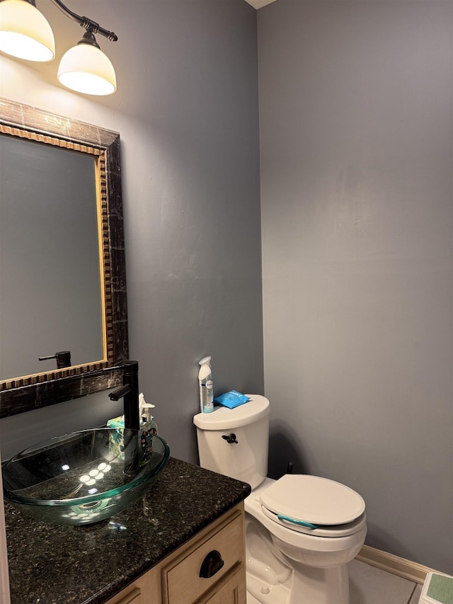 bathroom featuring vanity, tile patterned floors, and toilet