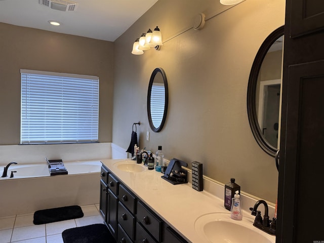 bathroom featuring tile patterned flooring, vanity, and a bathtub