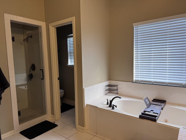 bathroom with toilet, independent shower and bath, tile patterned flooring, and a wealth of natural light