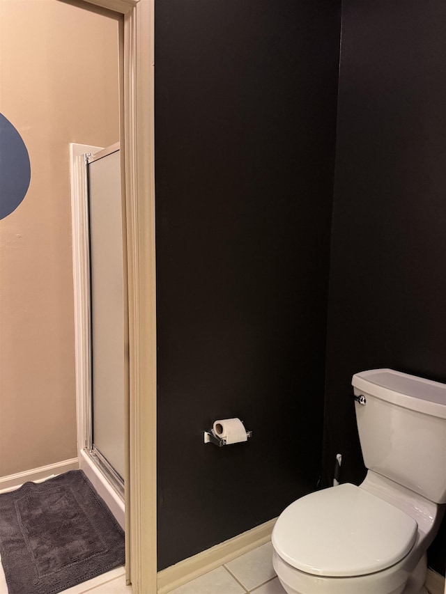 bathroom with walk in shower, tile patterned floors, and toilet