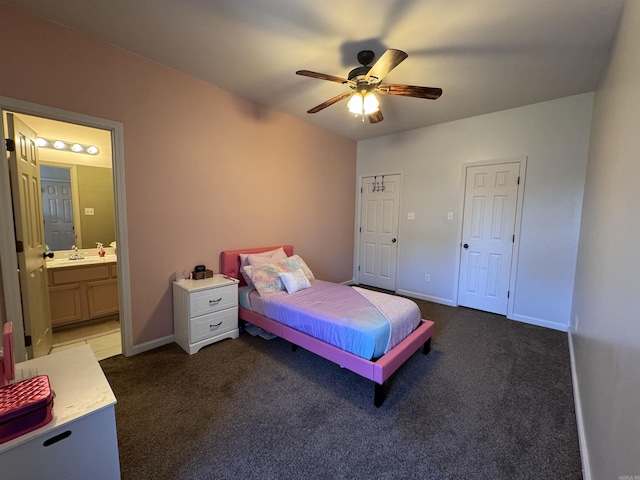 carpeted bedroom featuring sink, ceiling fan, and ensuite bathroom