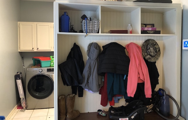 laundry area featuring cabinets, washer / clothes dryer, and light tile patterned floors