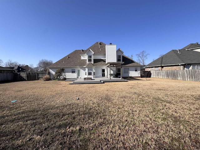 back of property featuring a patio and a lawn