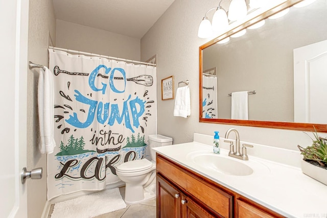 bathroom featuring tile patterned flooring, vanity, a shower with curtain, and toilet