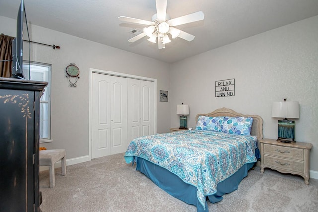 carpeted bedroom with a closet and ceiling fan