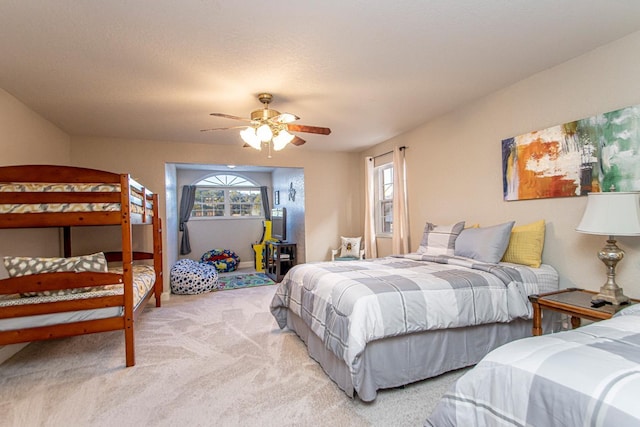 bedroom with ceiling fan and light carpet