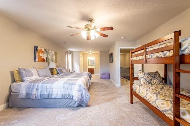 carpeted bedroom with ceiling fan and a textured ceiling