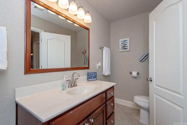 bathroom with vanity, toilet, and tile patterned flooring