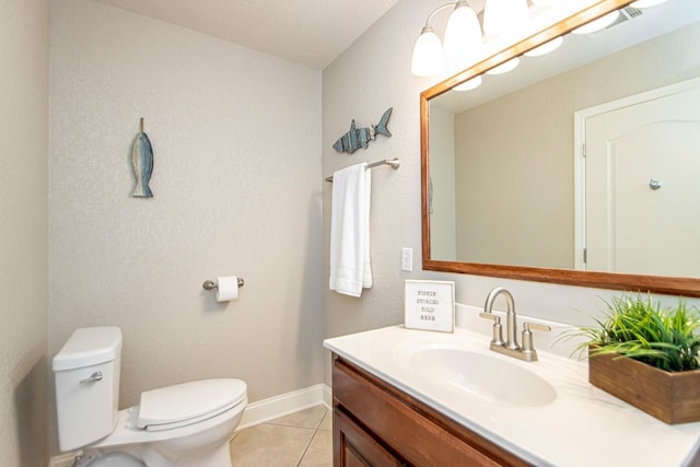 bathroom with vanity, toilet, and tile patterned flooring