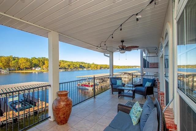 view of patio with a water view, a balcony, outdoor lounge area, and ceiling fan