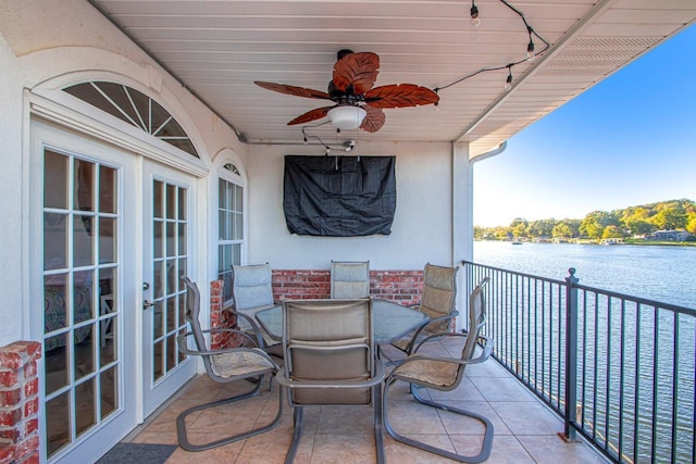 balcony featuring french doors, ceiling fan, and a water view