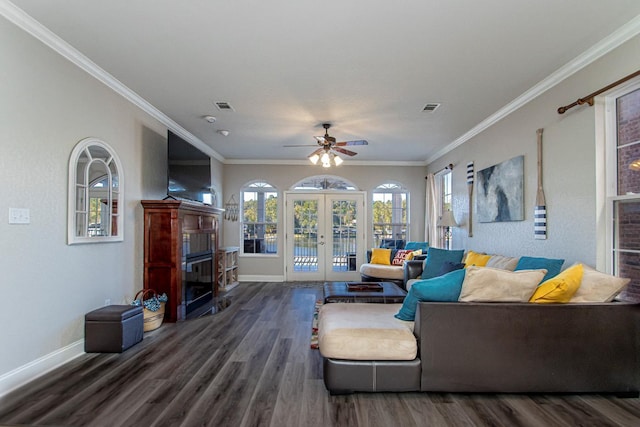 living room featuring dark hardwood / wood-style floors, ornamental molding, french doors, and ceiling fan