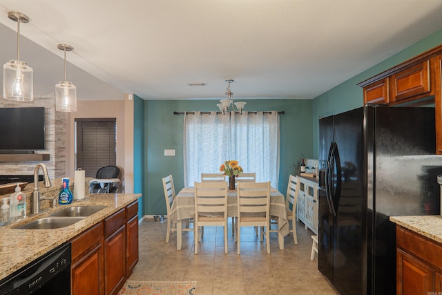 kitchen featuring sink, an inviting chandelier, hanging light fixtures, light stone countertops, and black appliances