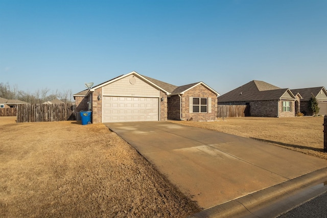 ranch-style house with a garage and a front lawn